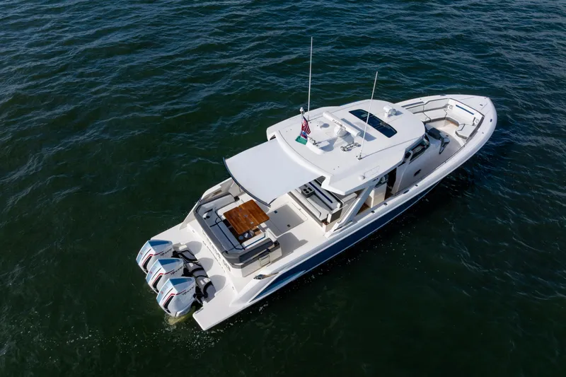 Slide: The Image of 2021 Tiara Yachts 43 LS cruising on open water, aerial view. - 14