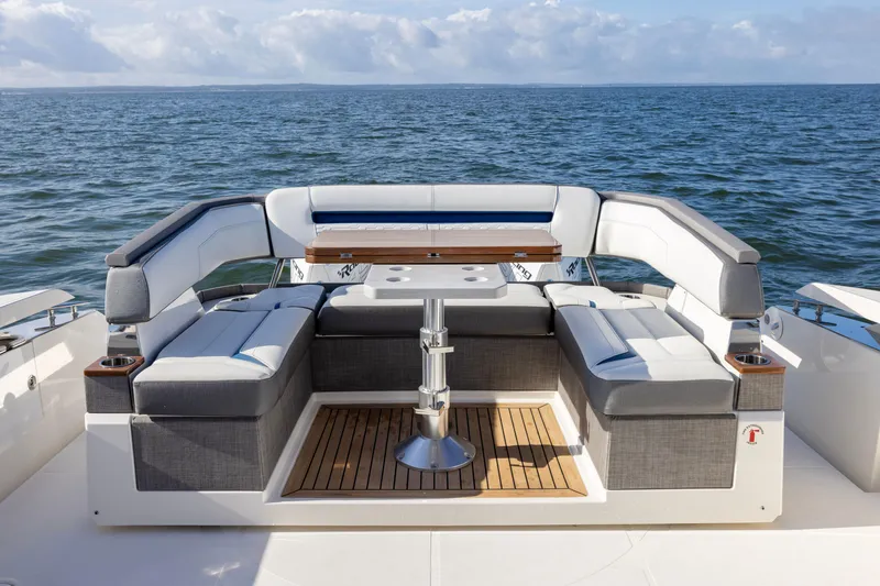 Slide: The Image of Luxury seating area on 2021 Tiara Yachts 43 LS, overlooking serene ocean waters. - 19