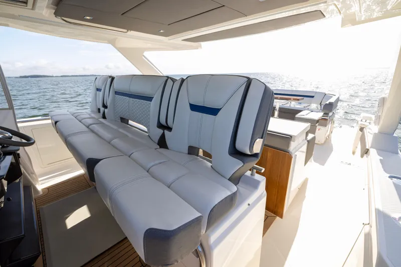 Slide: The Image of Luxurious seating on 2021 Tiara Yachts 43 LS, overlooking serene ocean waters. - 24