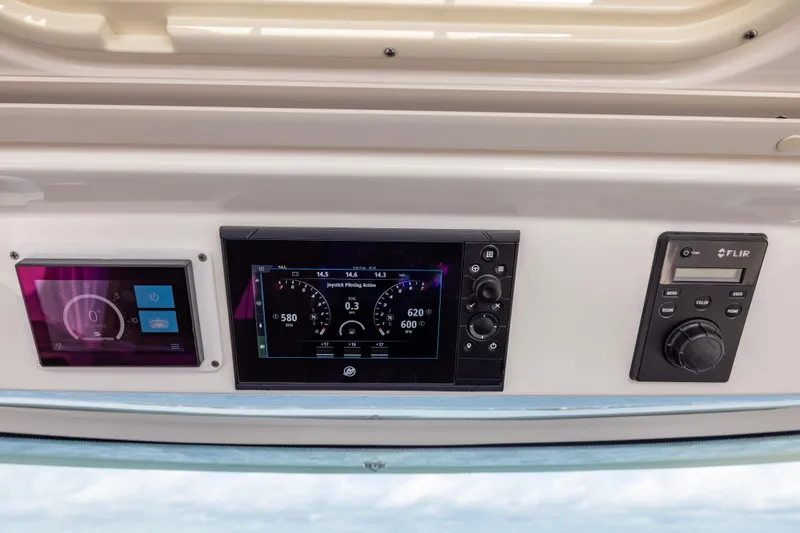 Slide: The Image of Control panel of 2021 Tiara Yachts 43 LS featuring navigation and monitoring systems. - 27