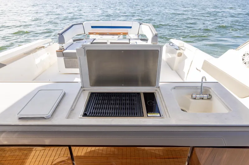 Slide: The Image of 2021 Tiara Yachts 43 LS with outdoor grill and sink, overlooking the water. - 30