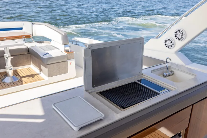 Slide: The Image of 2021 Tiara Yachts 43 LS yacht deck with grill and seating area. - 31