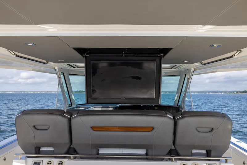 Slide: The Image of 2021 Tiara Yachts 43 LS interior with TV, ocean view, and luxury seating. - 33