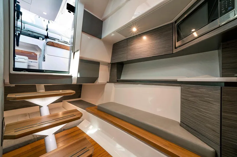 Slide: The Image of Manufacturer Provided Image: 2021 Tiara Sport 43 LS interior cabin with modern seating and kitchenette. - 36