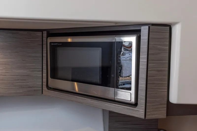 Slide: The Image of Built-in Sharp microwave in 2021 Tiara Yachts 43 LS, modern wood finish. - 38