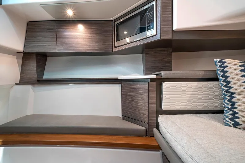 Slide: The Image of Manufacturer Provided Image: 2021 Tiara Sport 43 LS interior with modern cabinetry and microwave - 39