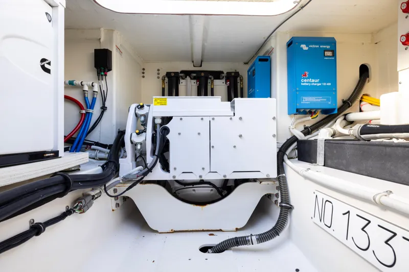 Slide: The Image of Engine room of 2021 Tiara Yachts 43 LS with battery chargers and wiring. - 46