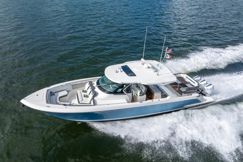 Slide: The Image of 2021 Tiara Yachts 43 LS cruising on open water, showcasing sleek design and powerful engines. - 5