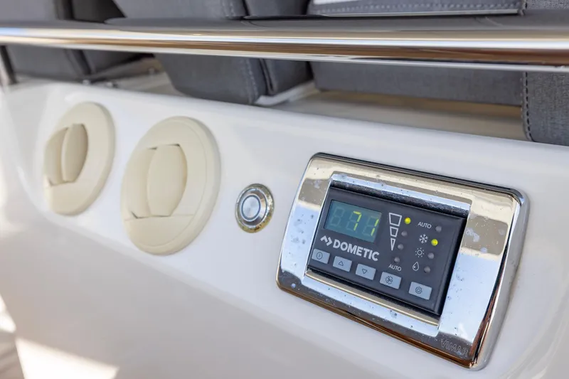 Slide: The Image of Control panel on 2021 Tiara Yachts 43 LS, featuring Dometic display and air vents. - 52