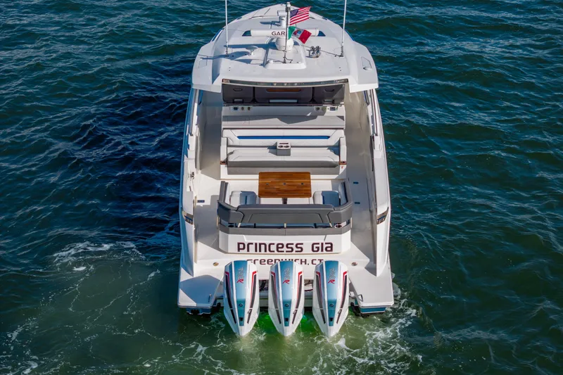 Slide: The Image of 2021 Tiara Yachts 43 LS on water, rear view with triple engines. - 55