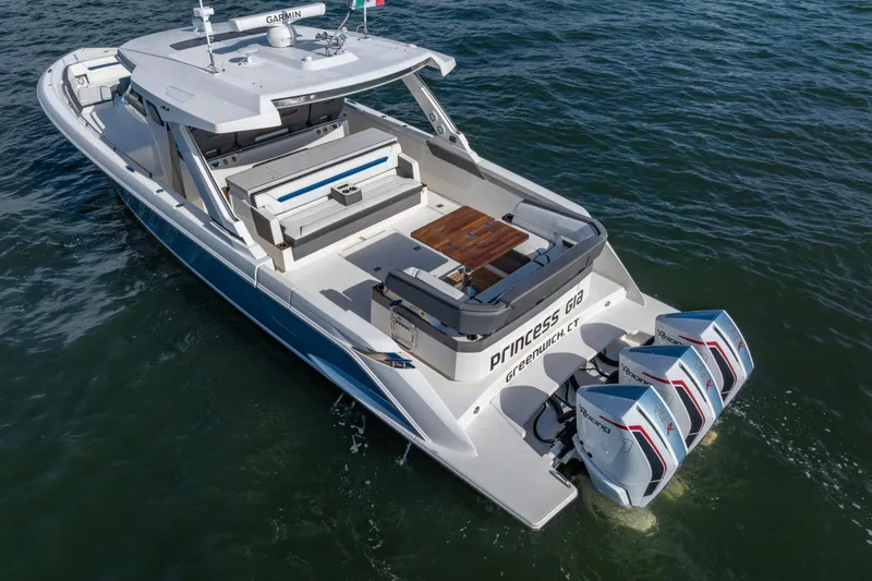 Slide: The Image of 2021 Tiara Yachts 43 LS boat with triple outboard engines on water. - 56