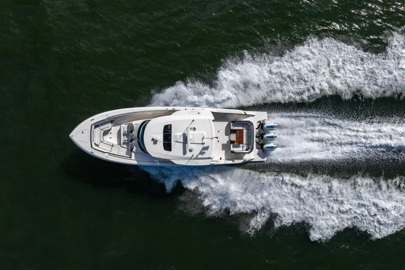 Slide: The Image of Aerial view of 2021 Tiara Yachts 43 LS speeding on water, leaving a wake. - 60