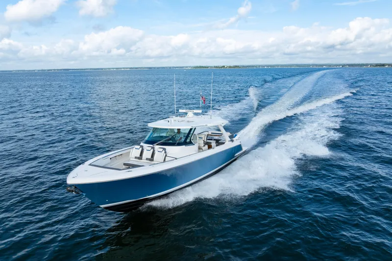 Slide: The Image of 2021 Tiara Yachts 43 LS cruising on open water under a clear sky. - 8