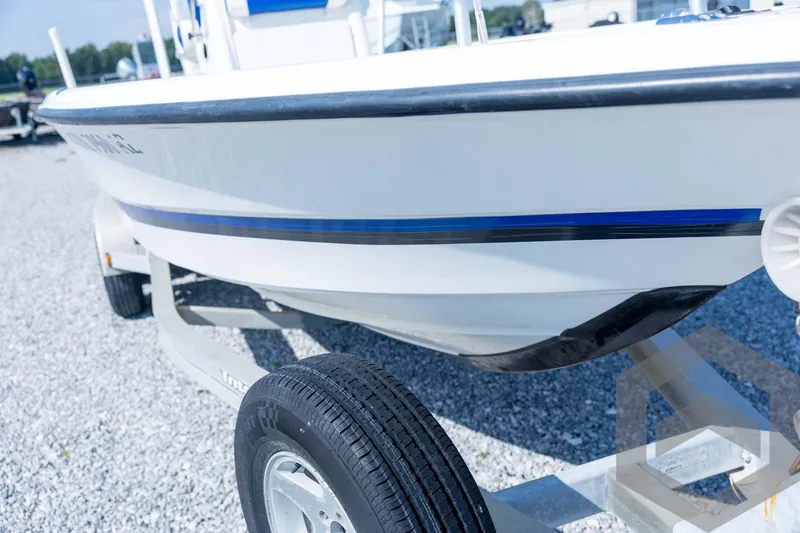 Slide: The Image of 2008 Triton 240 LTS boat on trailer, close-up view of hull and tire. - 11