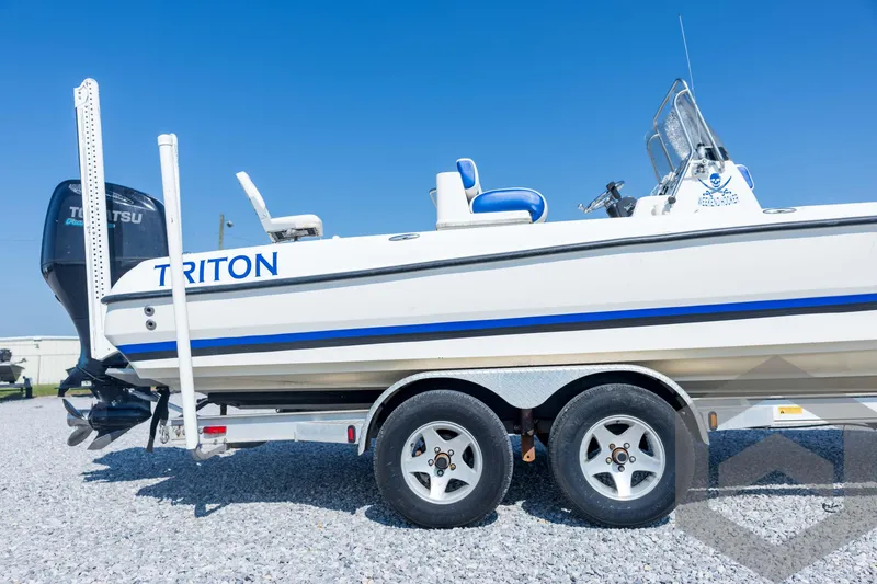 Slide: The Image of 2008 Triton 240 LTS boat on trailer, featuring Tohatsu outboard motor. - 14