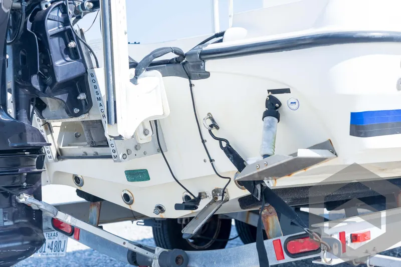 Slide: The Image of 2008 Triton 240 LTS boat's rear view with motor and trailer details. - 16