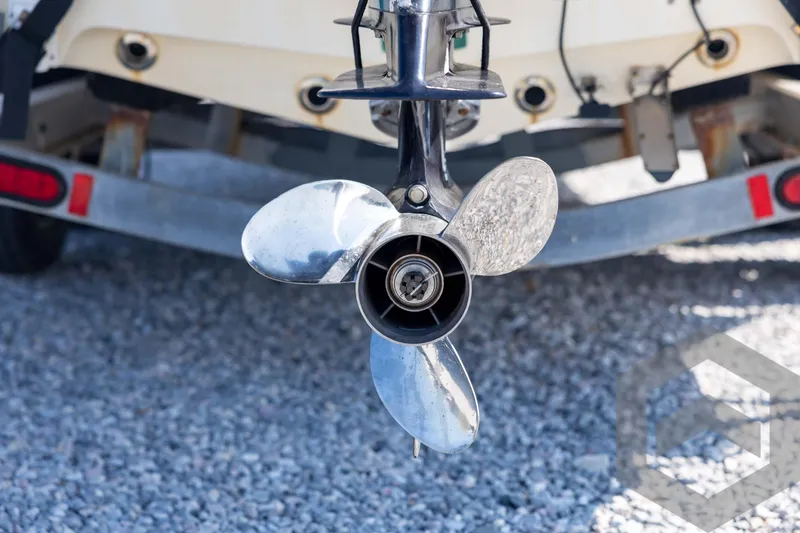 Slide: The Image of Propeller of a 2008 Triton 240 LTS boat on a gravel surface. - 18