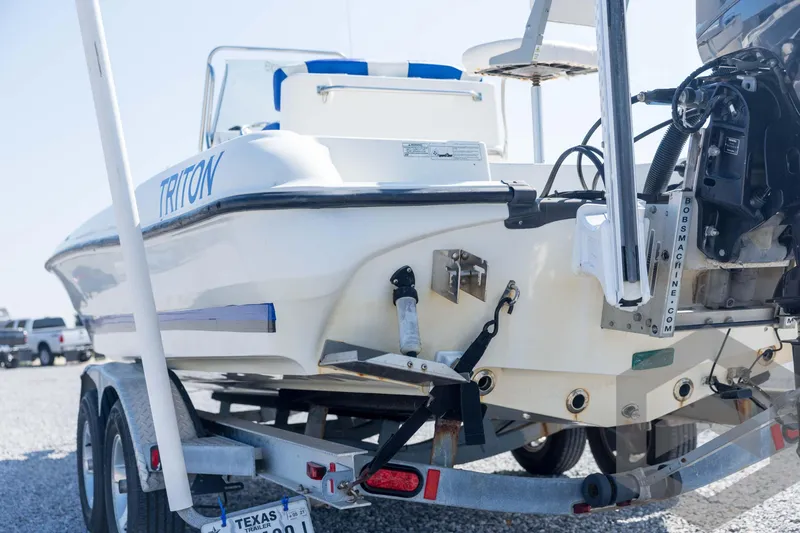 Slide: The Image of 2008 Triton 240 LTS boat on trailer, rear view, parked outdoors. - 21