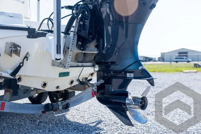 Slide: The Image of 2008 Triton 240 LTS boat motor and propeller on trailer, outdoor setting. - 22