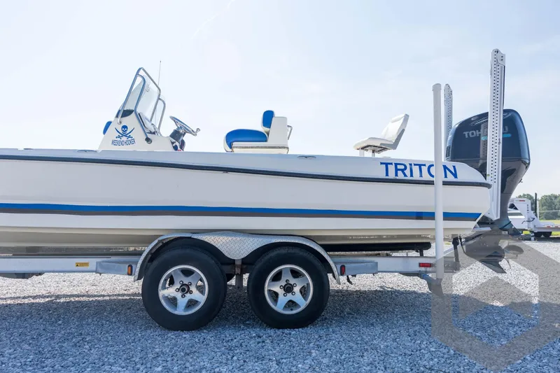 Slide: The Image of 2008 Triton 240 LTS boat on trailer, side view, with Tohatsu outboard motor. - 25
