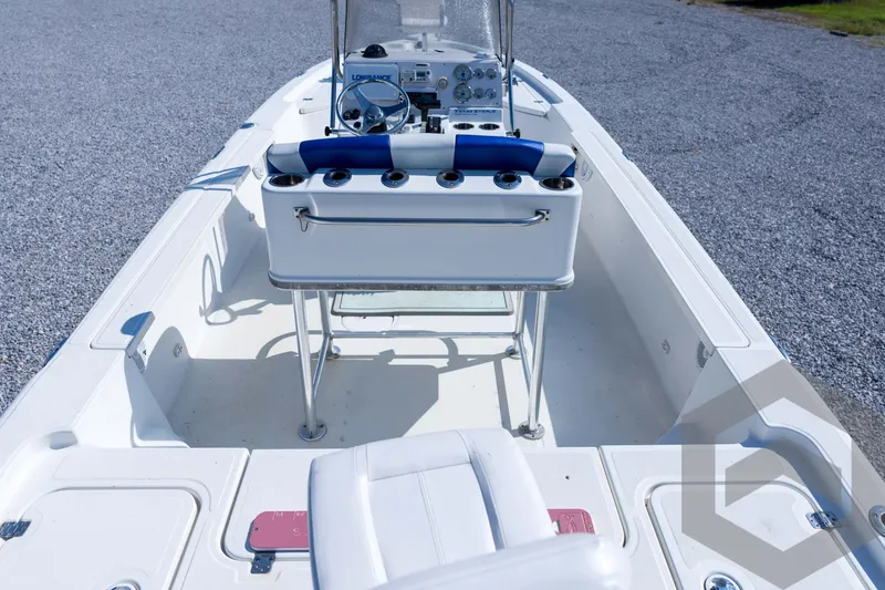 Slide: The Image of 2008 Triton 240 LTS boat interior with steering console and seating. - 28