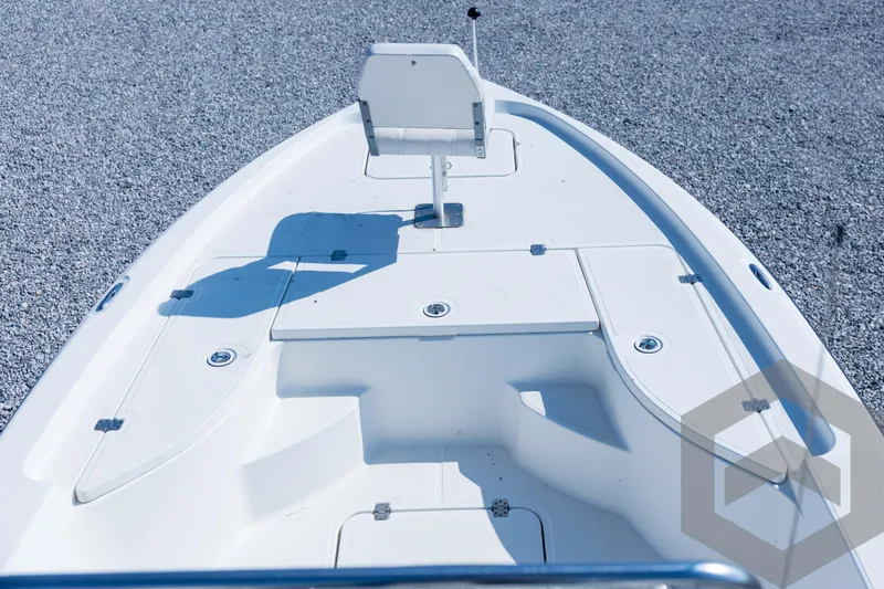 Slide: The Image of 2008 Triton 240 LTS boat deck with storage compartments and seating. - 29