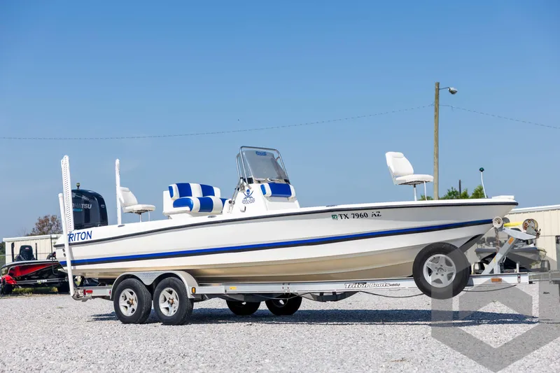 Slide: The Image of 2008 Triton 240 LTS boat on trailer, white with blue accents, parked outdoors. - 3