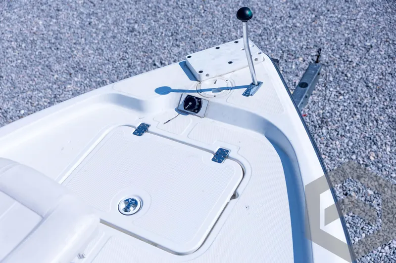 Slide: The Image of 2008 Triton 240 LTS boat deck with control lever and storage hatch. - 30