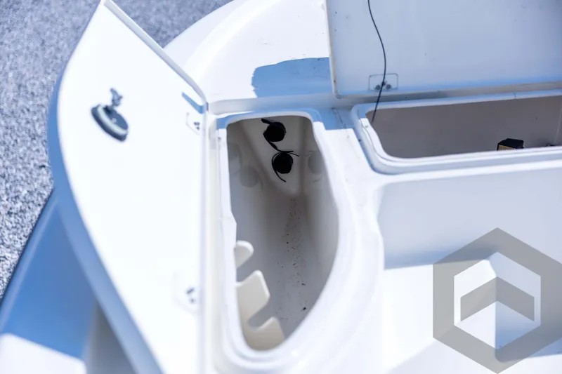 Slide: The Image of 2008 Triton 240 LTS boat storage compartments, open and empty, on a sunny day. - 33