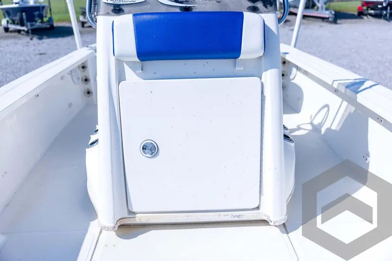 Slide: The Image of 2008 Triton 240 LTS boat console with blue seat, white storage compartment. - 36