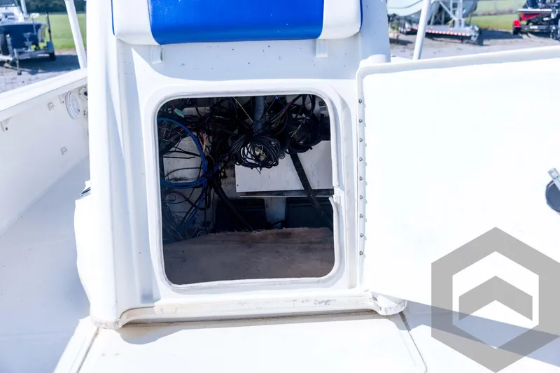Slide: The Image of 2008 Triton 240 LTS boat wiring compartment with open hatch and visible cables. - 37