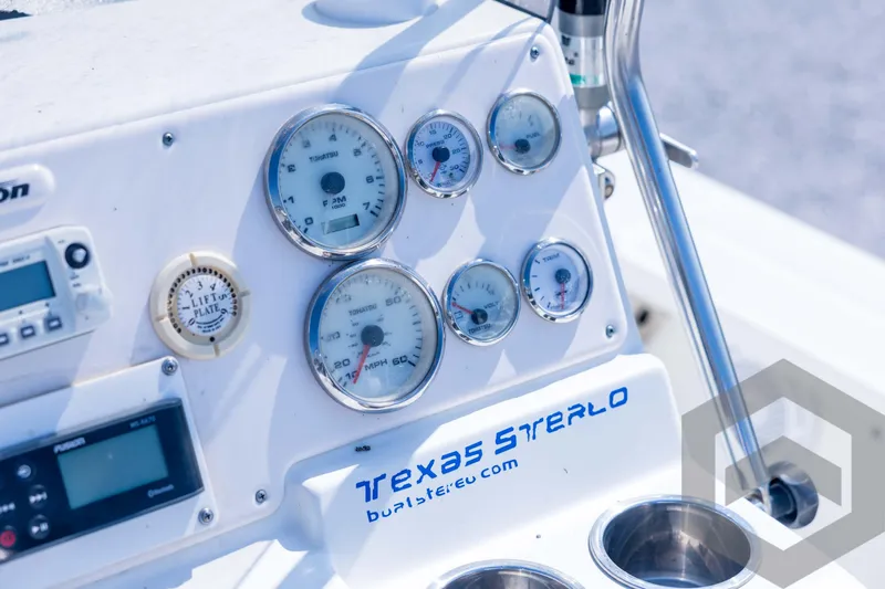 Slide: The Image of Dashboard of a 2008 Triton 240 LTS boat with gauges and controls. - 41