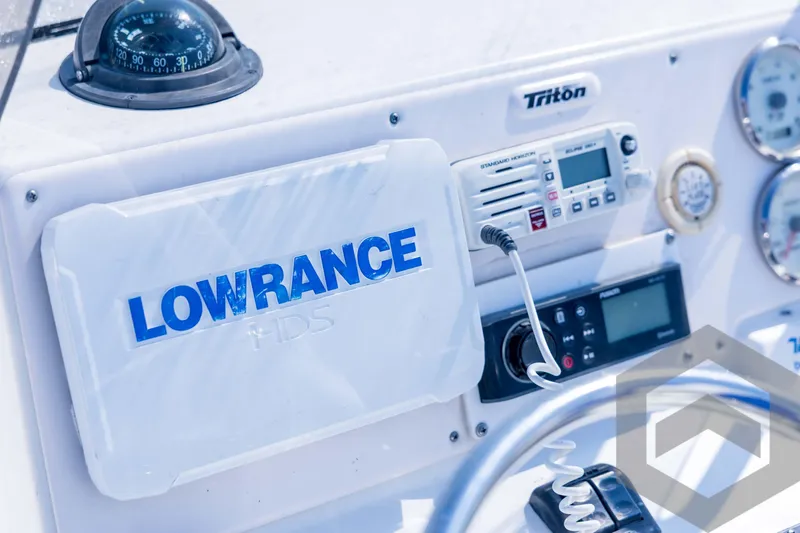 Slide: The Image of Control panel of 2008 Triton 240 LTS boat with Lowrance and radio equipment. - 42