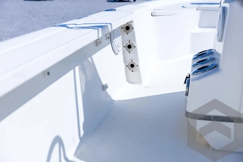 Slide: The Image of 2008 Triton 240 LTS boat interior, featuring rod holders and cup holders. - 44