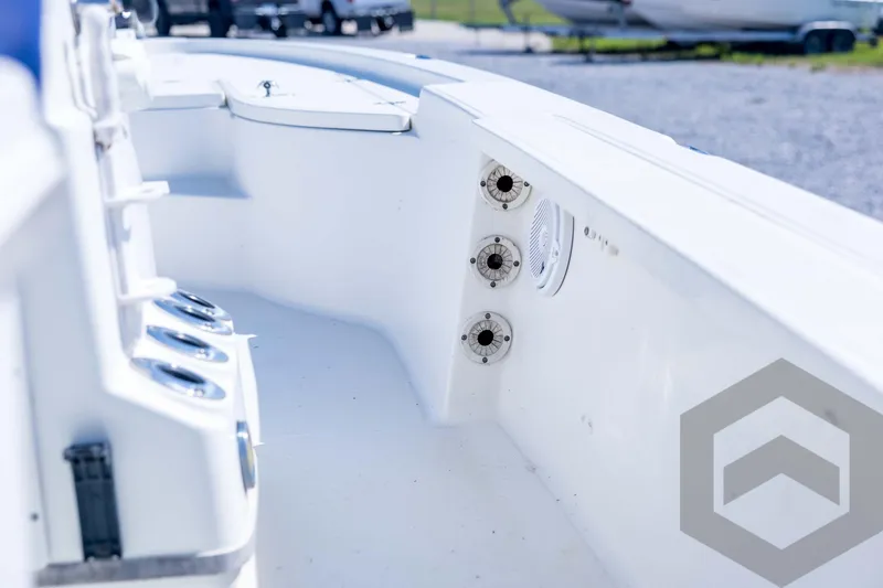 Slide: The Image of 2008 Triton 240 LTS boat interior, featuring rod holders and speaker. - 45