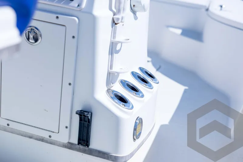 Slide: The Image of 2008 Triton 240 LTS boat interior with rod holders and storage compartment. - 46