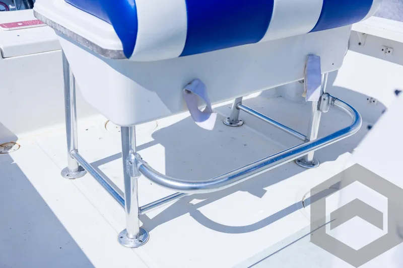 Slide: The Image of 2008 Triton 240 LTS boat seat with blue and white upholstery, chrome frame. - 50