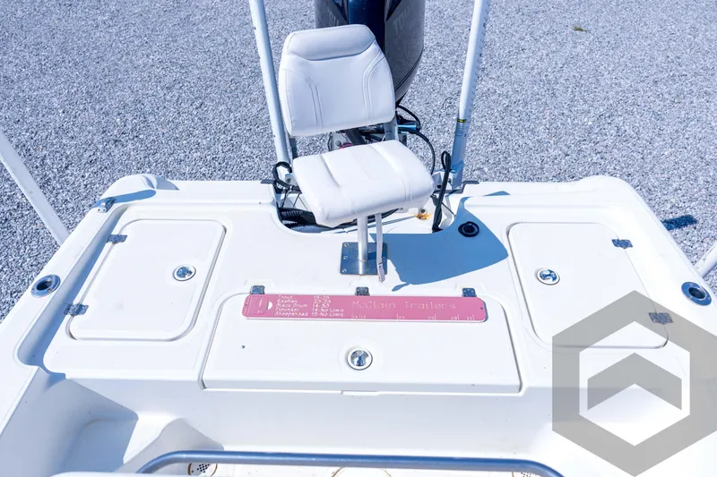Slide: The Image of 2008 Triton 240 LTS boat deck with white seat and storage compartments. - 54