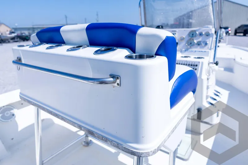 Slide: The Image of 2008 Triton 240 LTS boat interior with blue and white seating and cup holders. - 55
