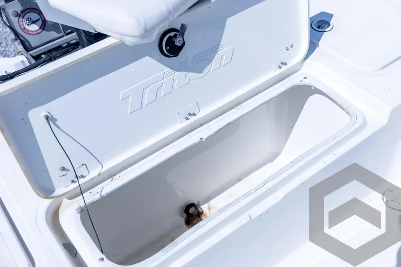 Slide: The Image of Open storage compartment on a 2008 Triton 240 LTS boat, showing interior details. - 56