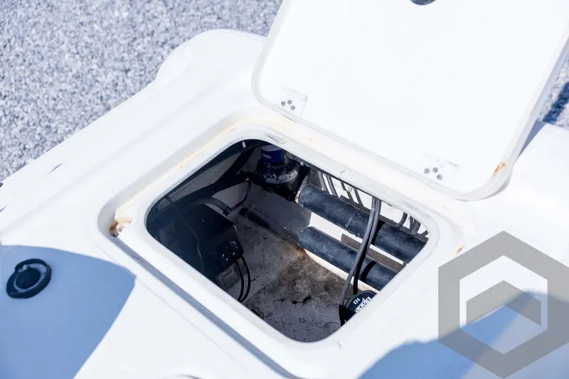 Slide: The Image of Open hatch on 2008 Triton 240 LTS boat showing internal components and wiring. - 58