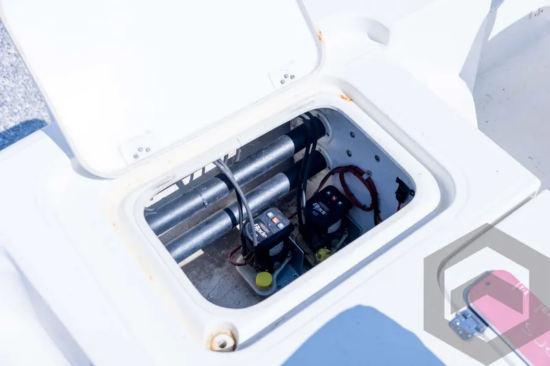 Slide: The Image of Open hatch of a 2008 Triton 240 LTS boat showing internal components. - 59