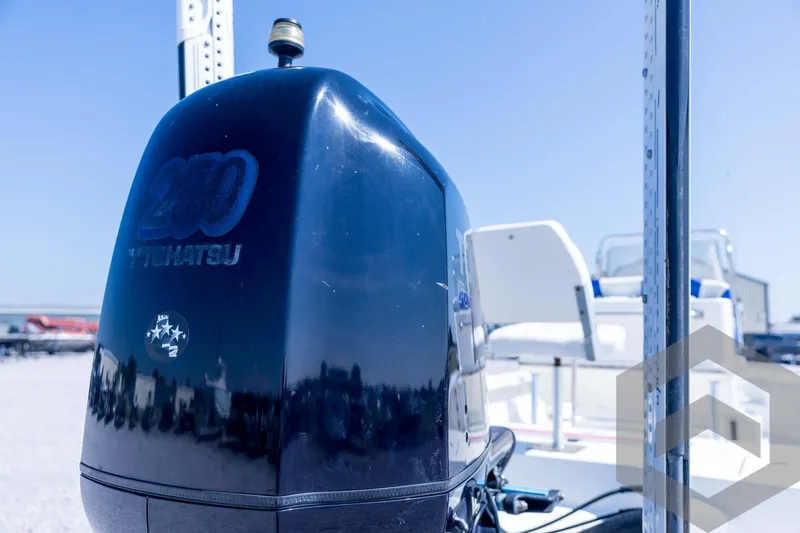 Slide: The Image of Triton 240 LTS 2008 boat with Tohatsu 200 engine, outdoor setting. - 62