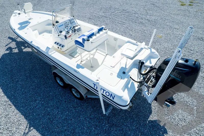 Slide: The Image of 2008 Triton 240 LTS boat on trailer, featuring a sleek design and powerful outboard motor. - 66
