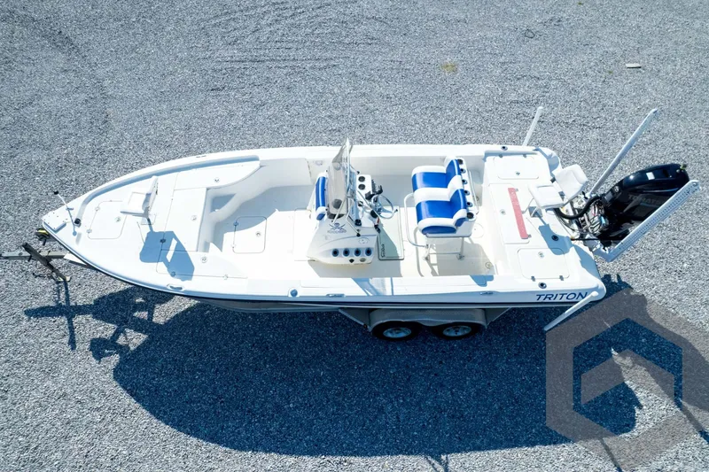 Slide: The Image of 2008 Triton 240 LTS boat on trailer, aerial view, parked on gravel surface. - 67