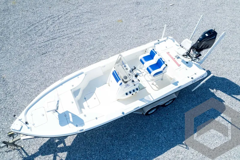 Slide: The Image of 2008 Triton 240 LTS boat on trailer, aerial view, white and blue design. - 68