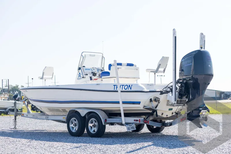 Slide: The Image of 2008 Triton 240 LTS boat on trailer, featuring Tohatsu outboard motor. - 7