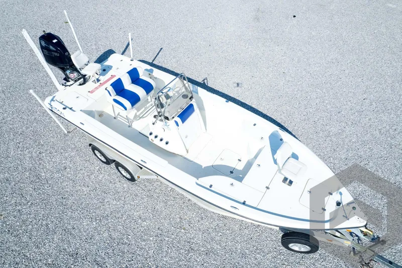 Slide: The Image of 2008 Triton 240 LTS boat on trailer, aerial view, white and blue seating. - 70