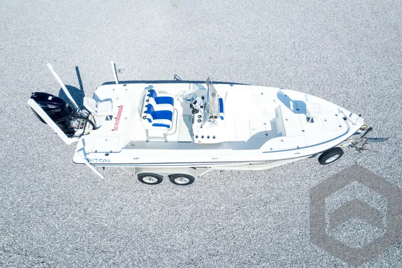 Slide: The Image of 2008 Triton 240 LTS boat on trailer, aerial view, white and blue design. - 71