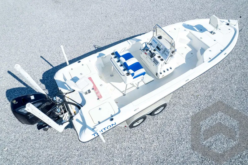 Slide: The Image of 2008 Triton 240 LTS boat on trailer, aerial view, white and blue design. - 72